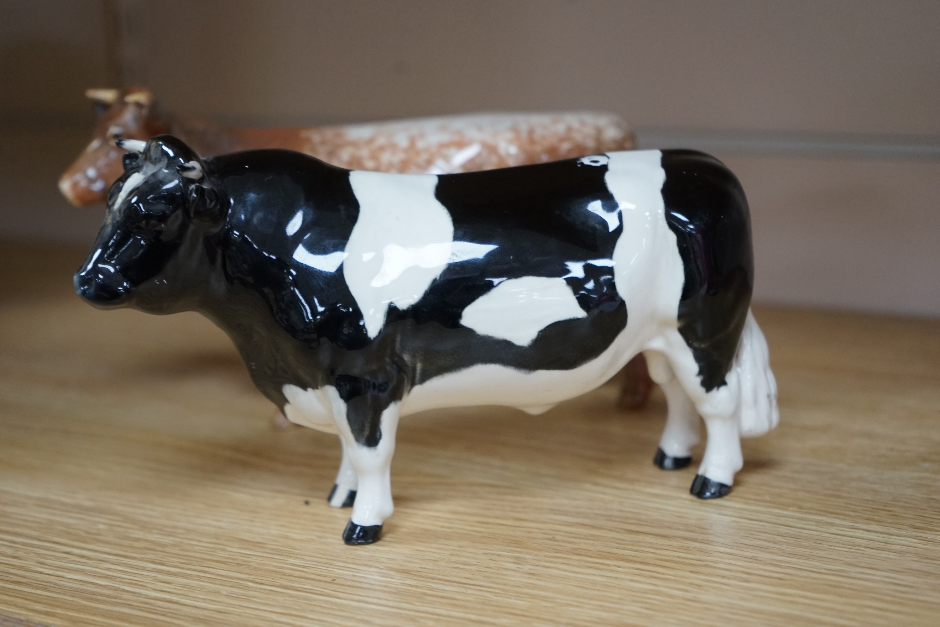 A Beswick model of a Shorthorn cow, ch. ''Eaton Wild Eyes 91st'', together with a Beswick Coddington Hilt Bar bull, 20cm. Condition - good